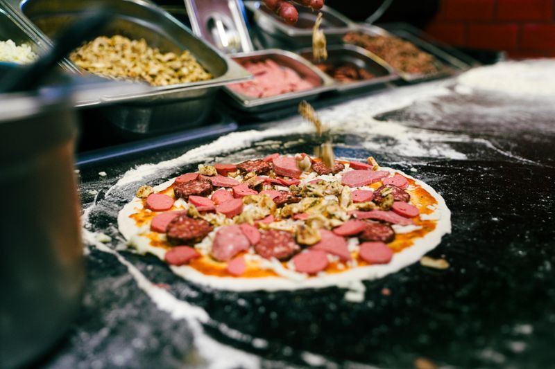 Pizza inn kitchen — chefs preparing fresh handcrafted pizza